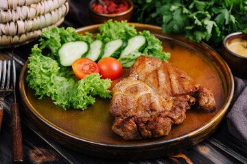 Grilled steaks and vegetables on plate