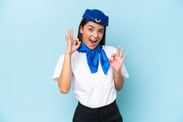 Airplane stewardess caucasian woman isolated on blue background showing an ok sign with fingers