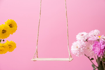 A swing with chrysanthemum flowers as a stand for your cosmetic product. Creative podium or...