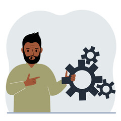 A man holds gears in his hand. Points a finger at the cogwheels. The concept of financial planning, movement, life, education or maintenance.