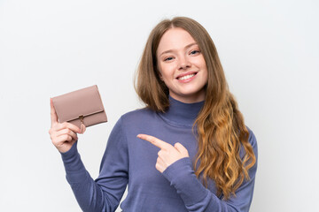 Obraz premium Young pretty woman holding wallet isolated on white background and pointing it