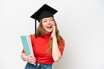 Young university graduate woman isolated on white background shouting with mouth wide open to the side