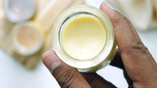 holding a Caramel pudding in a glass jar