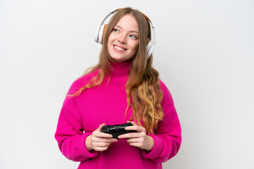 Young pretty woman playing with a video game controller isolated on white background thinking an idea while looking up