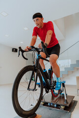 A man riding a triathlon bike on a machine simulation in a modern living room. Training during pandemic conditions.