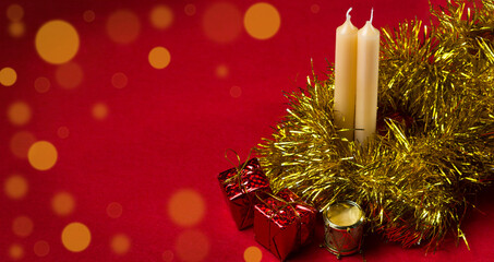 Christmas candle and Christmas decorations on a red background. Concept of christmas and new year. There is room for copy space