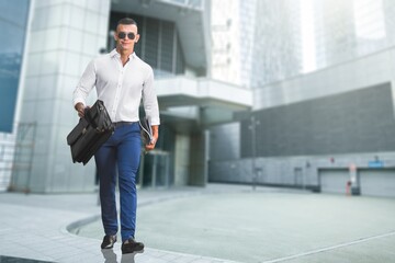 Young smart business man walking