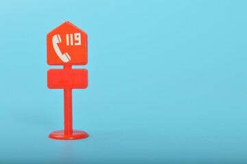 Red 911 sign isolated on a blue background. Emergency number 911.