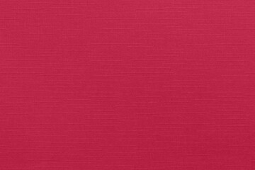 Empty decorative background with linen texture in Viva Magenta 2023 color. Pink-crimson design...