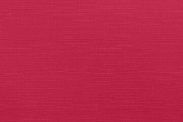 Empty decorative background with linen texture in Viva Magenta 2023 color. Pink-crimson design paper pattern with embossed lines and squares