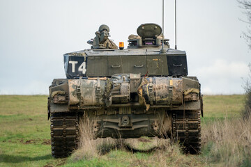 commander and gunner directing action in a British army FV4034 Challenger 2 ii main battle tank on a military combat exercise, Wiltshire UK