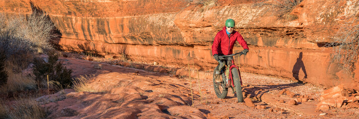 riding a fat mountain bike on a slickrock at the sandstone canyon bottom - Ruby Wash in Red Mountain Open Space north of Fort Collins, Colorado