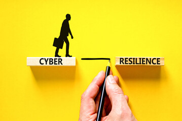 Cyber resilience symbol. Concept word Cyber resilience typed on wooden blocks. Beautiful yellow table yellow background. Businessman hand. Business and cyber resilience concept. Copy space.