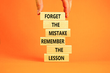 Lesson from mistake symbol. Concept words Forget the mistake remember the lesson on wooden blocks...
