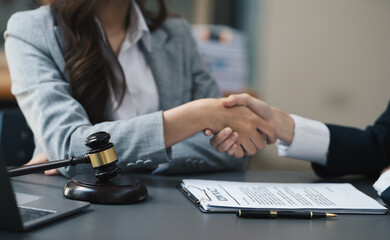 Asian female lawyer and business woman customer, Handshake after good deal agreement, Law and Legal concept.