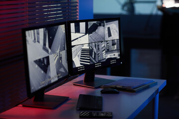 Background image of computer screens with surveillance camera footage in dark room with blue and red tones - obrazy, fototapety, plakaty
