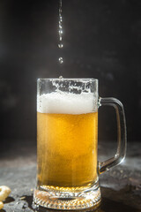 Light beer in a glass on a dark background