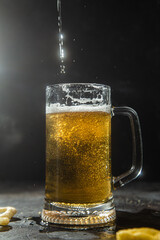 Light beer in a glass on a dark background