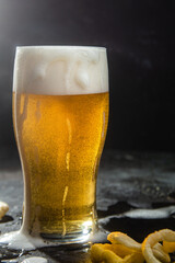 Light beer in a glass on a dark background