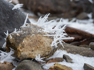 Ice and snow crystals grown on the surface of the stone after a hard frost