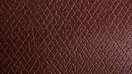 Close-up genuine leather texture, square checkered. Reddish brown color, natural wrinkled texture...