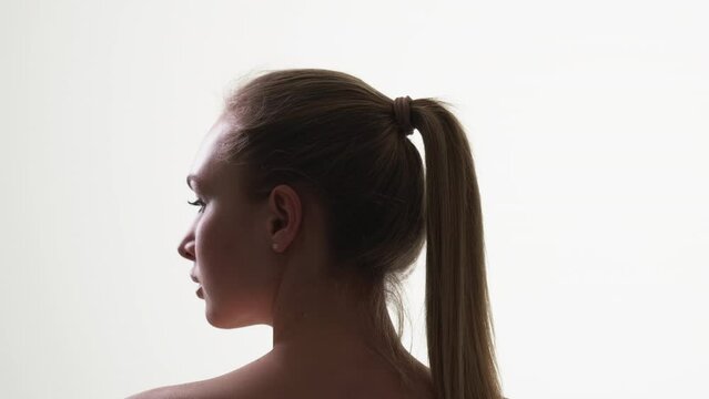 Female beauty. Profile silhouette portrait. Skincare treatment. Elegant sensual woman posing on white background.