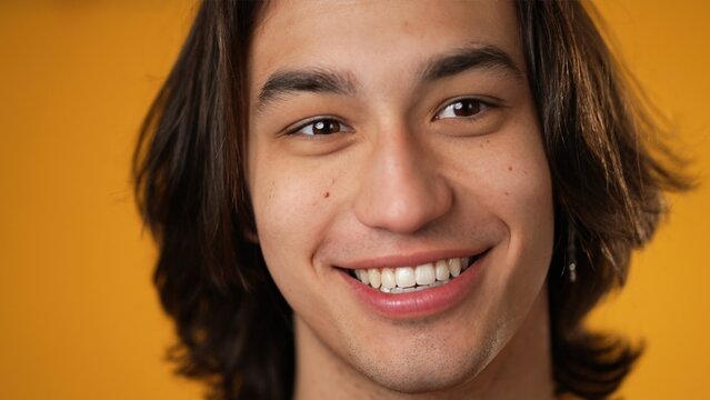Silly, Goofy, Funny Face Of Hispanic Gender Fluid Young Man 20s Posing Isolated On Yellow Background Studio.