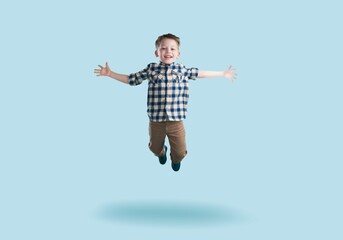 Obraz premium Energetic cute child jumping and posing