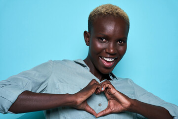 Glad African American woman gesturing heart