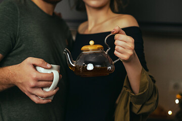 Man pouring tea during tea ceremony at home. Close up view. No face.