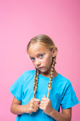 Vertical portrait of a cute girl with braids
