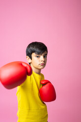 Boy wearing boxing gloves throwing a punch