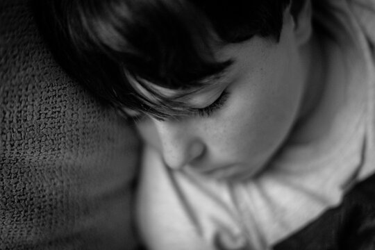 Close-up Of Boy With Bangs Asleep On The Armchair