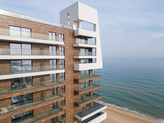 Aerial shot of modern luxury hotel facade with sea view