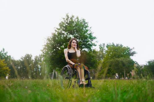 Young determined woman with paraplegia smiling.