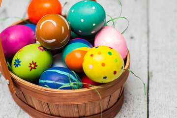 Basket with painted colorful easter eggs