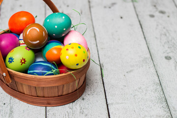 Basket with painted colorful easter eggs