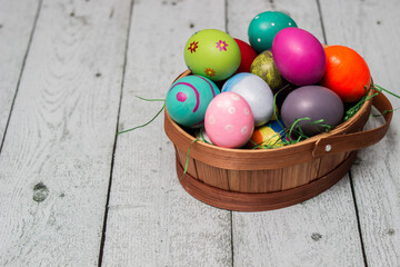 Basket with painted colorful easter eggs