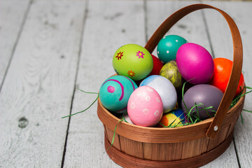 Basket with painted colorful easter eggs