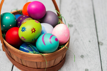 Basket with painted colorful easter eggs