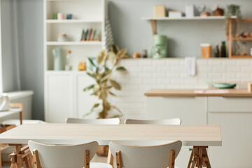Background image of cozy kitchen interior with dining table set in minimal white tones, copy space