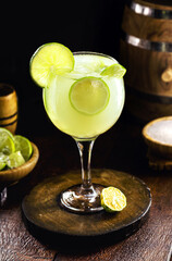 Caipirinha, typical Brazilian alcoholic drink made with cachaça, lemon, sugar and fruits, cold summer drink in a rustic setting