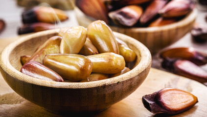 pine nuts in rustic wooden bowl, traditional brazilian winter food, brazilian restaurant food