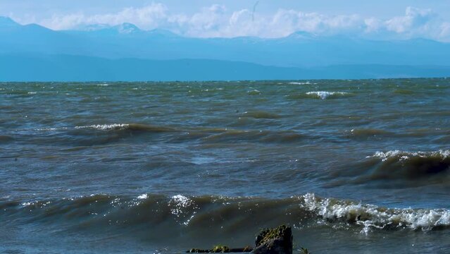 Close view waves in the lake.  Close view Sevan lake in Armenia, Caucasus. Mountain lake. Polluted lake.  