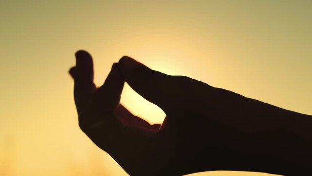 yoga hand sign. girl sunset doing yoga. female meditation glare sun. yoga stretching exercise. concentration outdoors concept. weight loss healthy lifestyle. fingers hand. hand gesture sunset. sport.