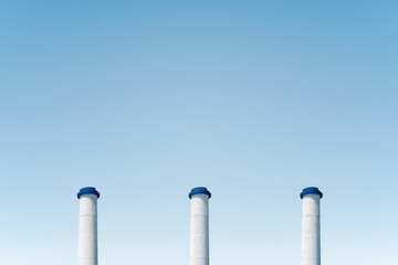 The blue sky and three smokeless chimneys.