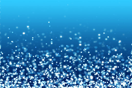 Water blue white glitter particles with abstract blurred light as decoration and background