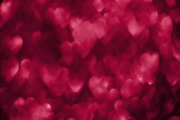 Trendy viva magenta, pink red hearts, sparkling glitter bokeh background, valentines day abstract defocused texture. Color of the year 2023