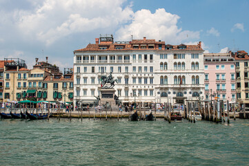 Fototapeta na wymiar View of the Venice Canal embankment on a warm summer day, with floating boats and old houses, Venice, Italy