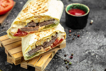 Turkish kebab wrap shawarma sandwiches with juicy cutlet and vegetables. Tasty fresh wrap...